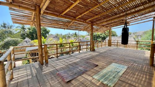 a large wooden deck with a pergola at SHANTI SURF CAMP in El Paredón Buena Vista
