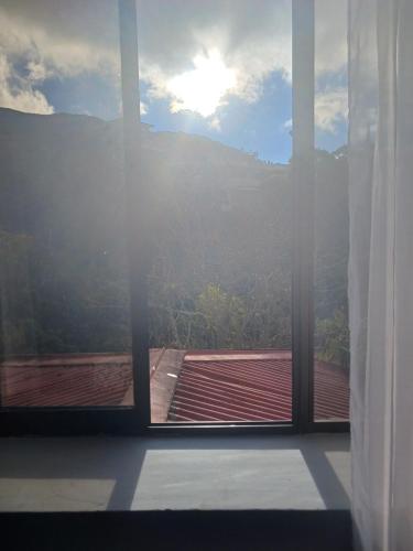 a window with a view of a mountain view at Habitaciones el mirador in San José