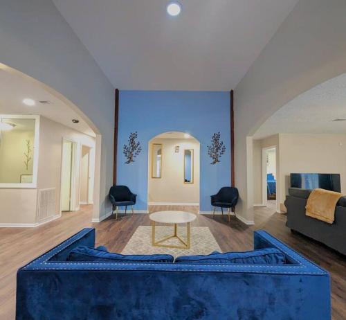a living room with a blue couch and a table at Quiet, Spacious, Pet-Friendly in Humble