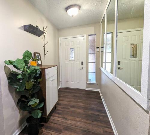 a room with a hallway with a door and a plant at Quiet, Spacious, Pet-Friendly in Humble