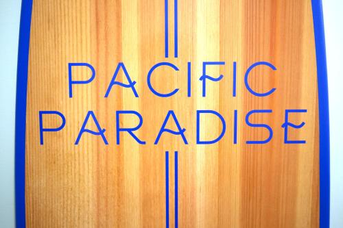 a book with the words pacific paradise written on it at Luxury Beach Home - Steps to the Sand, Game Room, Firepit, Deck in Oxnard