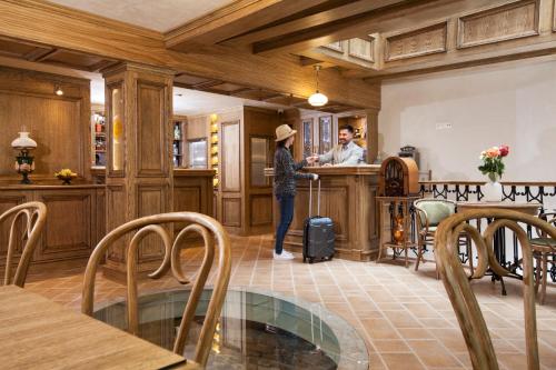 a woman standing at a counter in a kitchen at Villa Flavia Heritage Boutique Hotel in Plovdiv