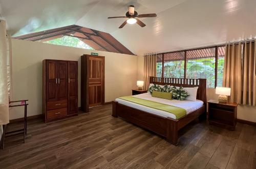 1 dormitorio con 1 cama y ventilador de techo en Pachira Lodge, en Tortuguero