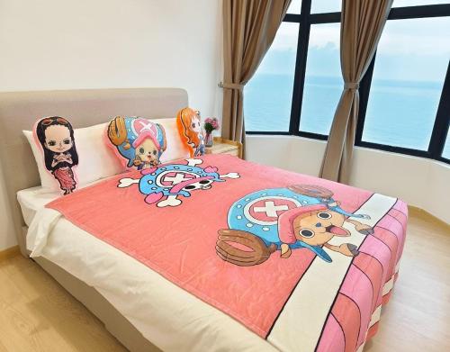 a bedroom with a bed with dolls on it at Mutiara Melaka Beach Resort by Glex in Tangga Batu