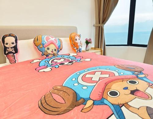 a bedroom with a bed with a stuffed animal on it at Mutiara Melaka Beach Resort by Glex in Tangga Batu