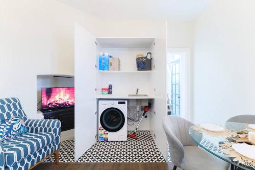 a living room with a washing machine and a tv at Water front - KING 3 Room Rooftop The Rocks #E2 in Sydney