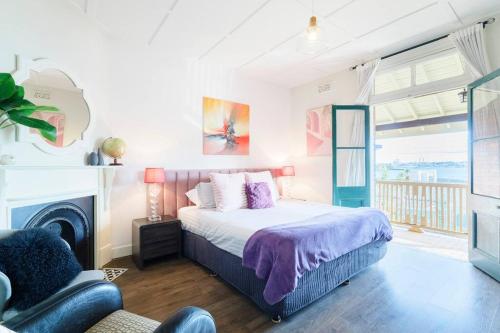 a bedroom with a bed and a fireplace at Water front - KING 3 Room Rooftop The Rocks #E2 in Sydney