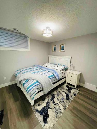 a bedroom with a bed and a nightstand and a bed sidx sidx sidx sidx at Cozy*Bright*Modern 2 Bedroom guest suite in Edmonton