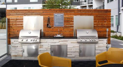 a barbecue grill with two burners on a patio at Cozysuites l Luxe 1BR in Downtown Cincinnati in Cincinnati