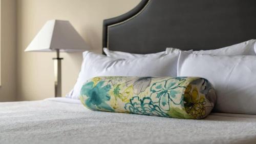 a pillow sitting on top of a bed at CozySuites TWO Stunning Condo with SKY POOL in Dallas