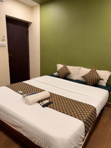 two beds sitting next to each other in a room at David Residency in Madurai