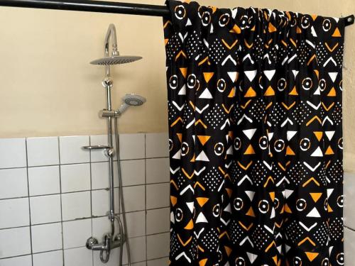 a shower curtain in a bathroom with a black at Independent room on Island in colonial house with private entrance in Saint-Louis