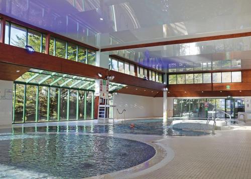 a large indoor swimming pool in a building at Shorefield Country Park in Milford on Sea
