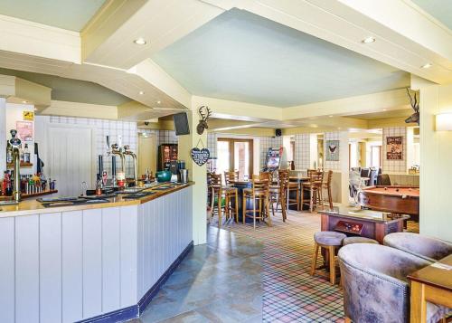 a living room with a bar and a pool table at Pickering Lodges in Pickering