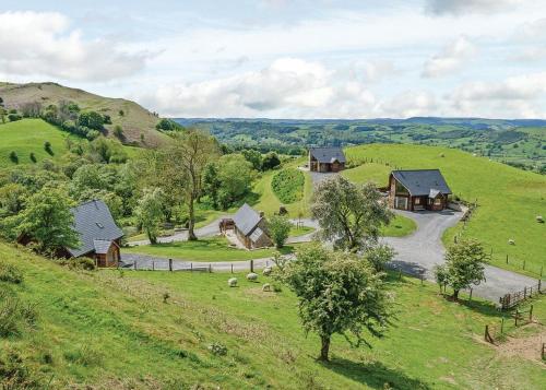 an aerial view of a farm with houses on a hill at Slate House Lodges in Llandinam