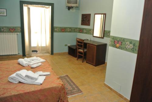 a room with two beds and a desk with white shoes at Locanda degli Illustri in Civitanova del Sannio