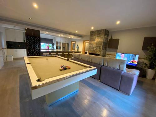 a large living room with a pool table in it at 4 bedrooms villa with private pool jacuzzi and terrace at Rebordoes Souto in Rebordões