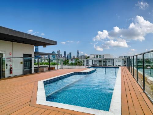 a swimming pool on the roof of a building at Brisbane Luxury Gabba Apartment in Brisbane