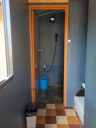 a bathroom with a shower with a hose at Tupi's Beachfront Minihouse in Bacungan