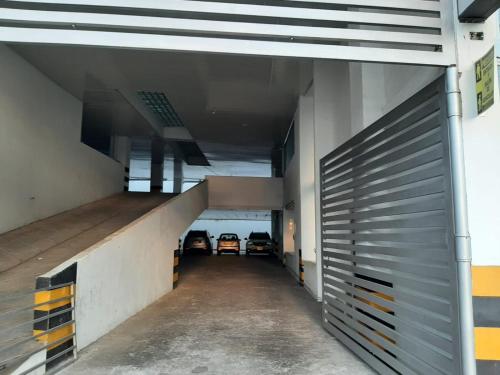 an empty parking garage with two cars parked in it at Hotel Inara in Girardot