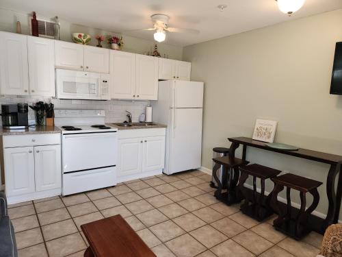 a kitchen with white appliances and a table with chairs at Seaside Bliss Awaits Your Dream Beach Getaway! in Hilton Head Island