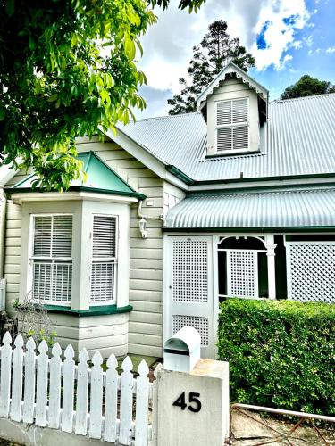 a white fence in front of a house at Charming heritage house in the heart of the city in Brisbane