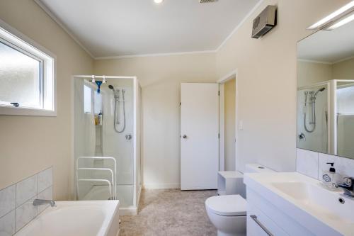 a bathroom with a toilet sink and a shower at Garden Retreat - Napier Holiday Home in Napier