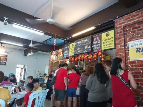 a group of people queuing at a fast food restaurant at CY Homestay in Kampar