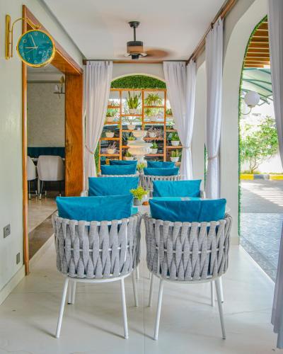 a dining room with blue chairs and a table at La Fattoria Resort in Mombasa