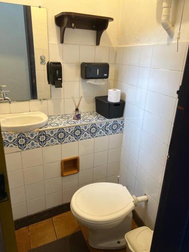 a bathroom with a toilet and a sink at History Hostel in Ouro Preto