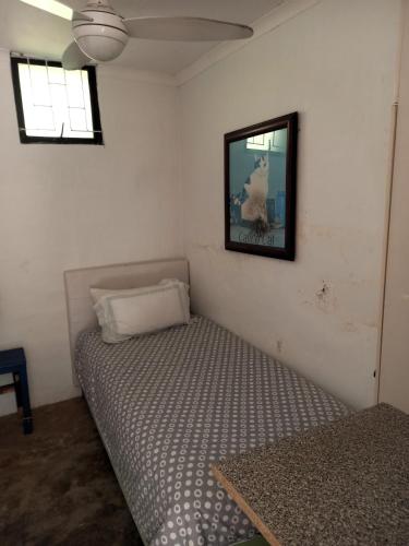 a bedroom with a bed and a picture on the wall at Ocean Walk Garrick in Zinkwazi Beach