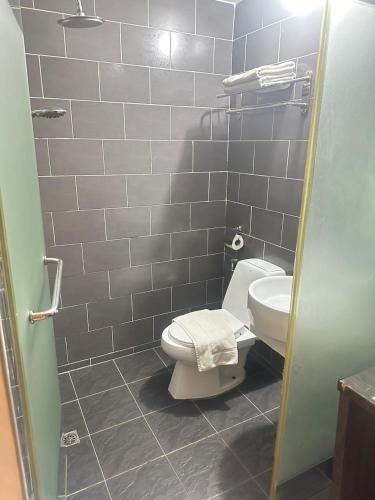 a bathroom with a toilet and a sink at KINGSMAN BOUTIQUE HOTEL in Kota Kinabalu