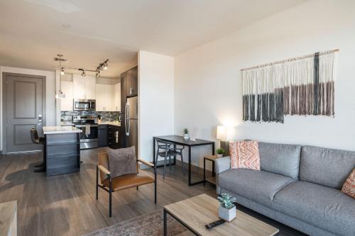 a living room with a couch and a kitchen at Modern CozySuites on the Town Lake waterfront 15 in Tempe