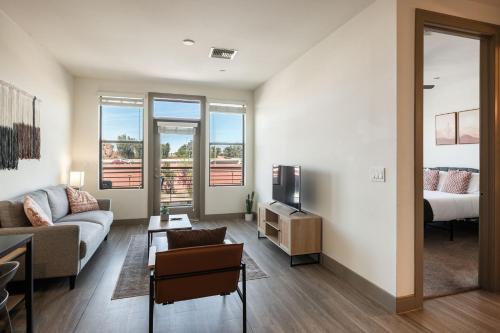 a living room with a couch and a tv at Modern CozySuites on the Town Lake waterfront 15 in Tempe