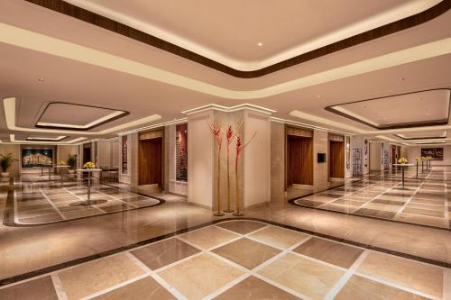 a lobby of a hotel with a large lobby at Aurika, Mumbai International Airport - Luxury by Lemon Tree Hotels in Mumbai