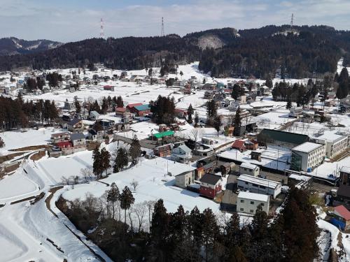 an aerial view of a town covered in snow at Bandai in Tokamachi