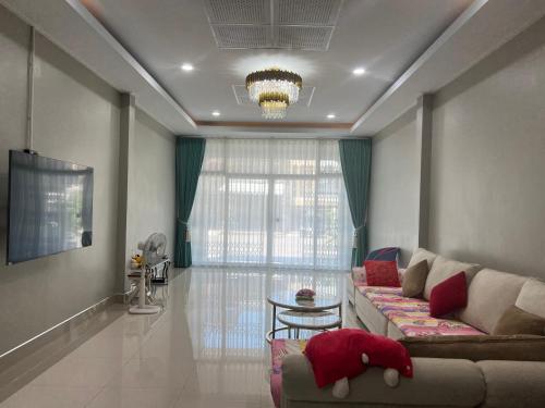 a living room with a couch and a table at Pani House ( Hatyai 3 ) in Hat Yai