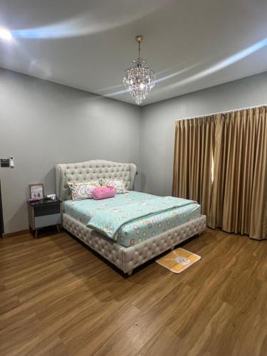 a bedroom with a bed and a chandelier at Pani House ( Hatyai 3 ) in Hat Yai