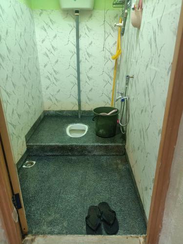 a small bathroom with a toilet and a bucket at Saffira Homestay Near Universiti Malaya Education Centre -UMEC in Bachok