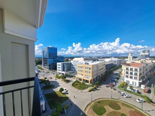 a view of a city from a balcony of a building at Saint Honore Executive 1 Full bed, 1 Sofa bed 1 Pull out bed 2BR in Iloilo City