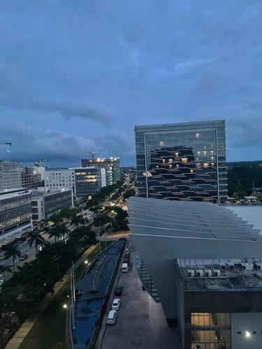 a view of a city with a train station and buildings at Saint Honore Executive 1 Full bed, 1 Sofa bed 1 Pull out bed 2BR in Iloilo City