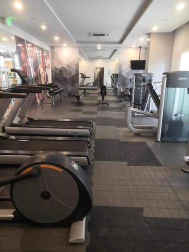 a gym with a toilet in the middle of a room at Saint Honore Executive 1 Full bed, 1 Sofa bed 1 Pull out bed 2BR in Iloilo City