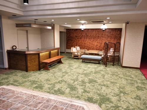 a room with a podium and a table and chairs at Kannabi Ikomayama Hotel in Ikuma