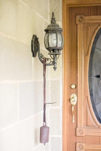 a lamp hanging on a wall next to a door at Rural Apartment with Stunning Views in Relbia