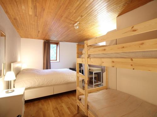 - une chambre avec deux lits superposés et un plafond en bois dans l'établissement Mont-Dore : Duplex T3 avec Parking, à 300m du centre - FR-1-608-268, à Le Mont-Dore