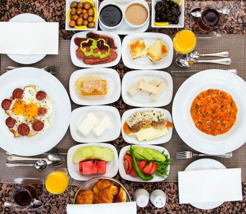 a table full of plates of food with different foods at Hilton Istanbul Bosphorus in Istanbul
