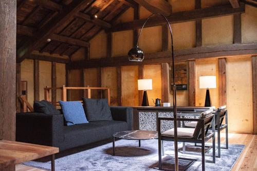 a living room with a couch and a table at NIPPONIA HOTEL Ozu Castle Town in Ōzu