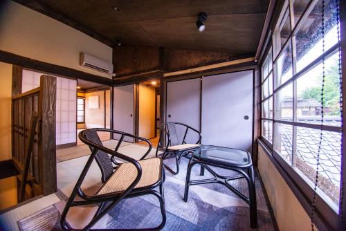 two chairs sitting on the balcony of a house at NIPPONIA HOTEL Ozu Castle Town in Ōzu