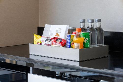 a tray of food and drinks on a table at Grande Centre Point Sukhumvit 55 Thong Lo in Bangkok