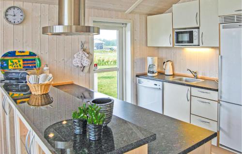 a kitchen with white cabinets and a counter top at Cozy Home In Haderslev With Wifi in Flovt